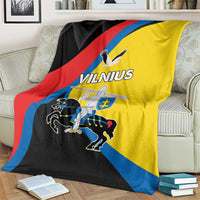 Vilnius flag blanket on armchair; yellow, black, red, and blue diagonal design