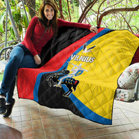 Vilnius flag quilt laid across sofa; black, red, yellow, and blue with crest and text