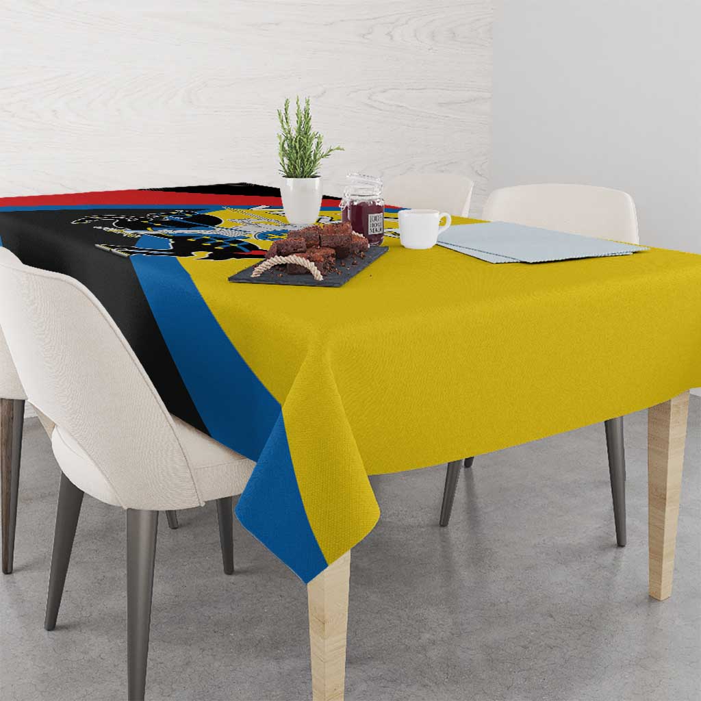Multicolor tablecloth draped on dining table with blue stripe and yellow underside visible