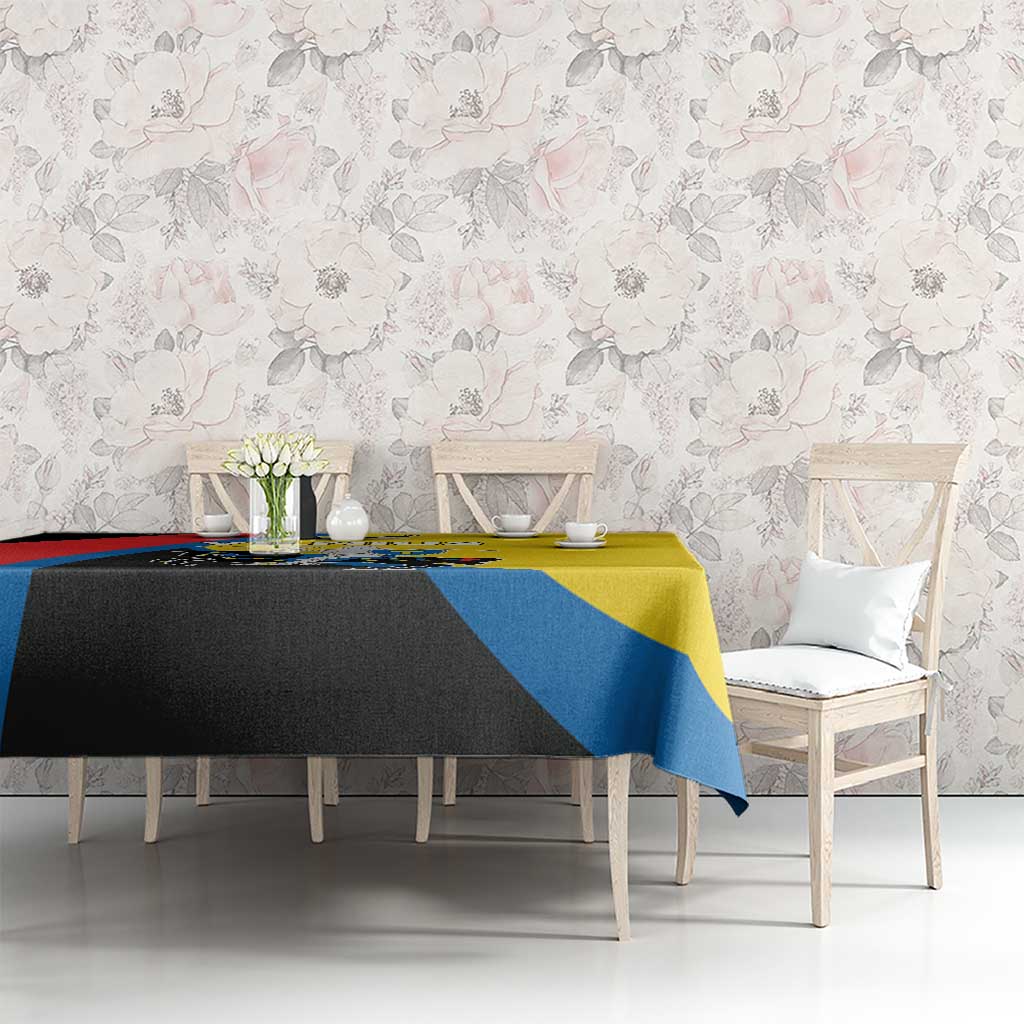 Multicolor tablecloth on dining table with yellow top, blue stripe, and black accent panel