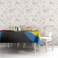 Multicolor tablecloth on dining table with yellow top, blue stripe, and black accent panel
