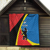 Red and blue quilt with yellow stripe and black diagonal panel featuring “TELSIAI” crest