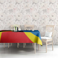 Flag-pattern tablecloth in red, yellow and blue with crest design, on dining table