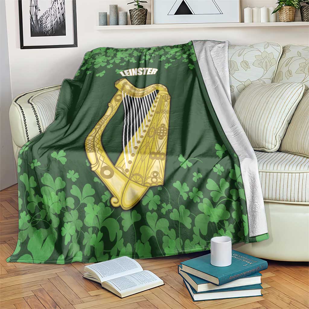 Green Leinster harp and shamrock pattern blanket draped on a couch