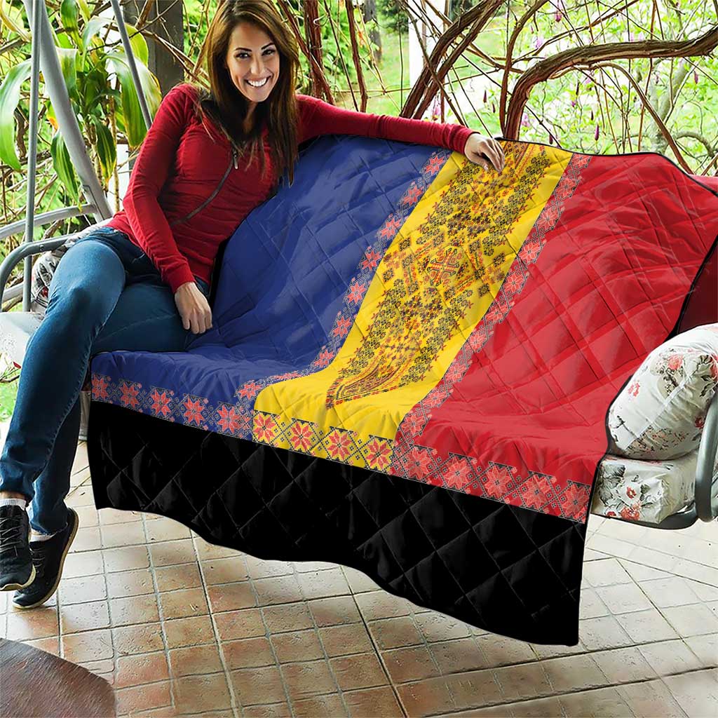 Traditional quilt laid out outdoors with blue and red halves, yellow stripe, and black base
