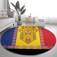Round decorative rug featuring yellow embroidery center, red and blue geometric border