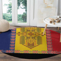 Round embroidered rug with yellow central design, blue and red border, black fabric edge