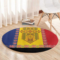 Round traditional embroidered carpet with yellow center, red and blue patterned sections, black edge