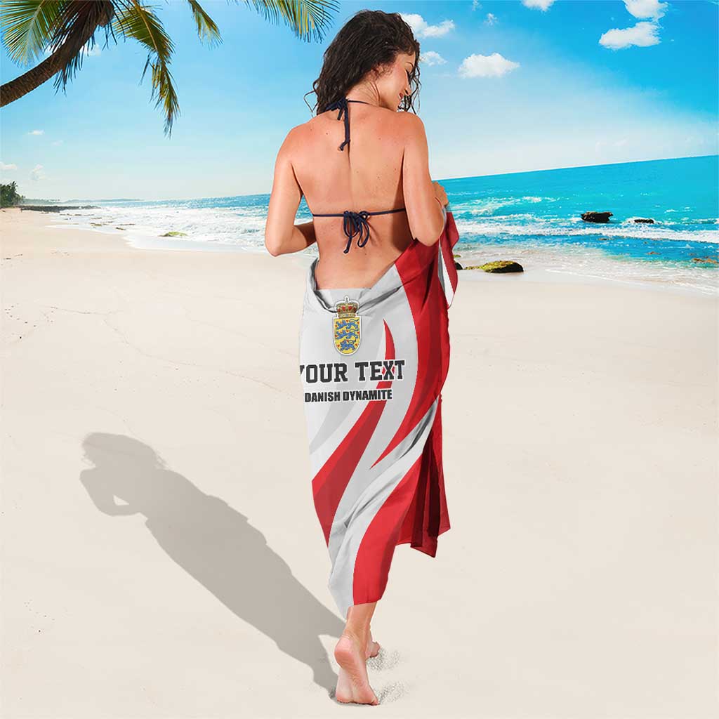 Red-and-white football sarong with bold swirl graphic and crest, tied for coverage
