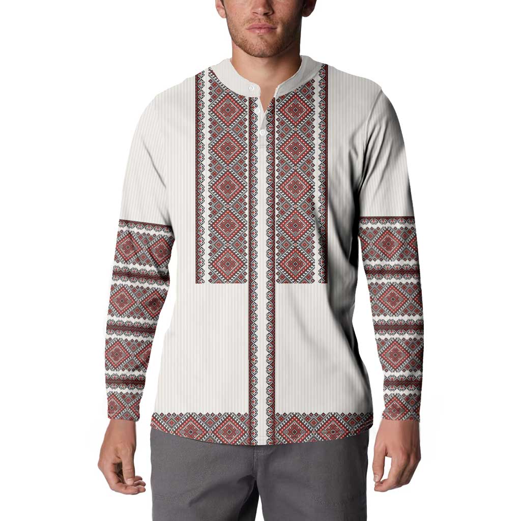 White button-front sweatshirt with red-and-black vertical embroidery panel and patterned cuffs