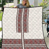 White quilt with red Ukrainian folk embroidery panels and diamond quilting