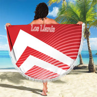 Red circular beach blanket with fringe, “Los Llanis” script and diagonal white stripes