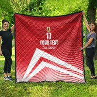 Red quilt blanket with diamond stitching, crest and number 17, white diagonal stripe design