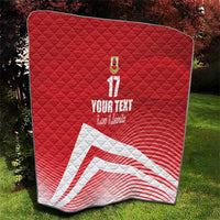 Red quilt blanket with diamond quilting, number 17 and crest, with white diagonal stripe graphic