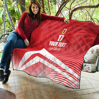 Red quilt blanket with diamond quilting, number 17 and crest, and white diagonal stripe graphic