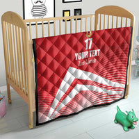 Red quilt blanket with diamond quilting, crest and number 17, with white diagonal stripe for crib