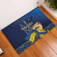 Personalized blue rubber doormat with yellow waving figure artwork and “Your text”