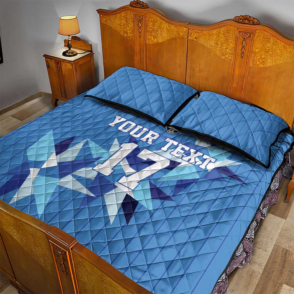 Blue quilt bed set with custom jersey text and geometric football pattern, two pillows