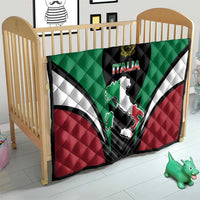 Quilt blanket on crib with green, white, red design and black Italia emblem