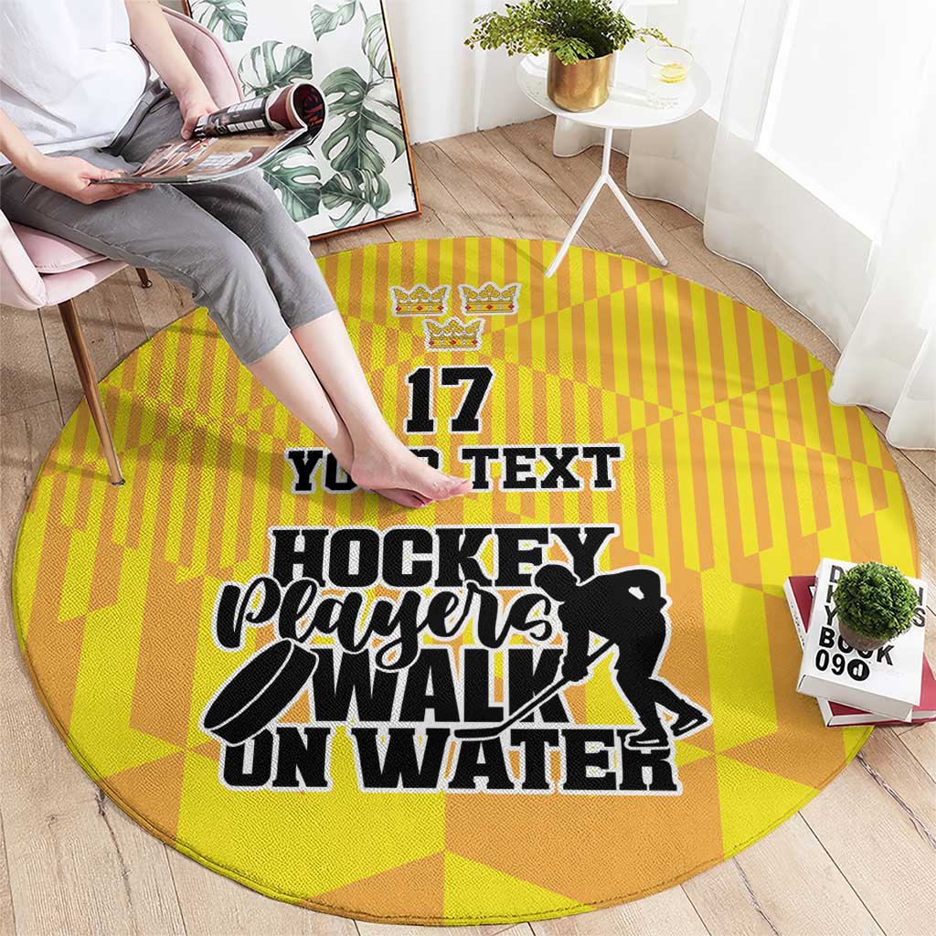 Round yellow hockey rug on floor with '17 YOUR TEXT' and 'Players Walk On Water' print
