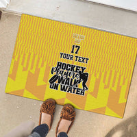 Yellow ice hockey doormat with hockey player graphic and crown above number 17
