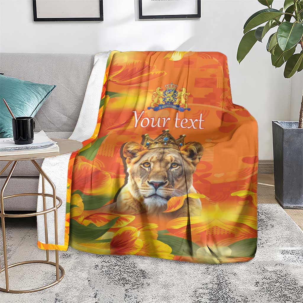 Orange personalized lion blanket with crown emblem and tulip flowers, on living-room chair