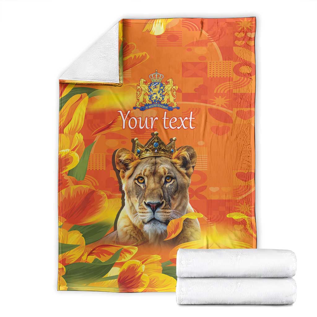 Orange personalized lion blanket with crown emblem and tulip flowers, shown with folded towels