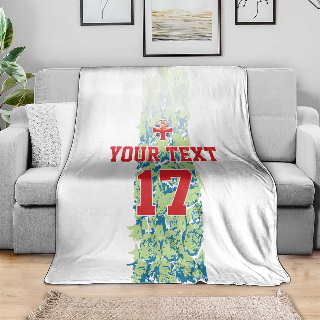 Custom football blanket draped on seating, white with number 17 graphic and red “YOUR TEXT”