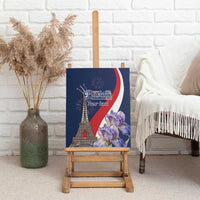 Blue canvas wall art on wooden easel with Eiffel Tower, fireworks, and purple flowers