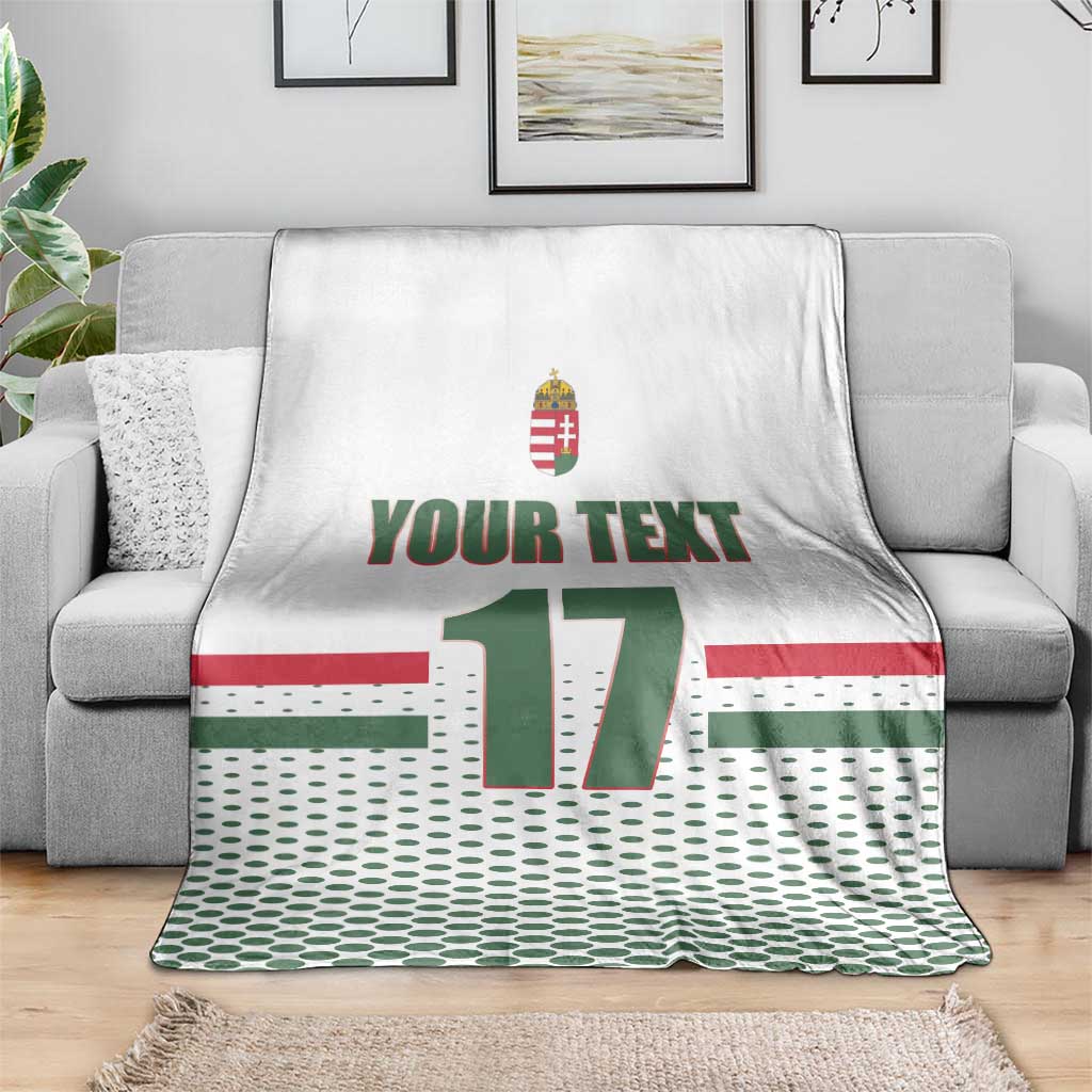 White custom ice hockey blanket on gray sofa; Hungary crest, 'YOUR TEXT', number 17