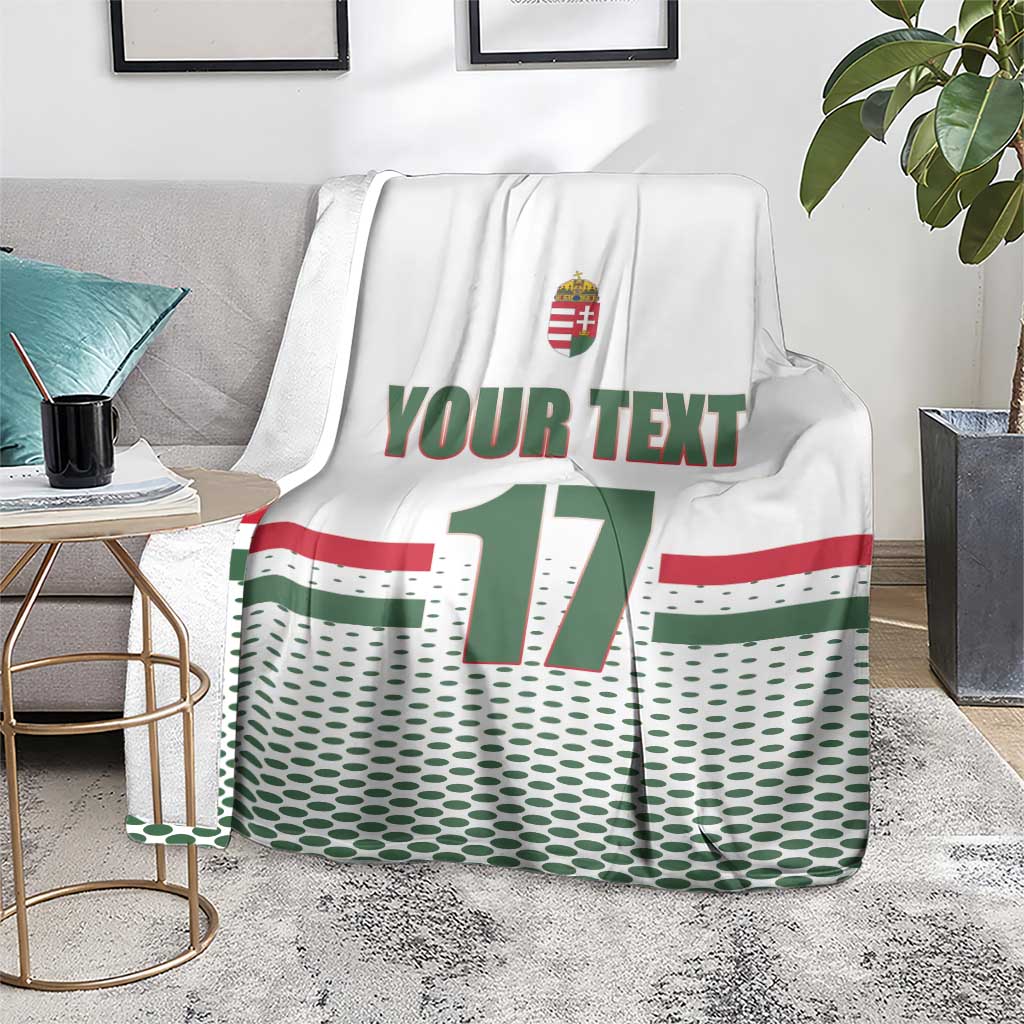 White custom ice hockey blanket over gray sofa; Hungary crest, 'YOUR TEXT', number 17