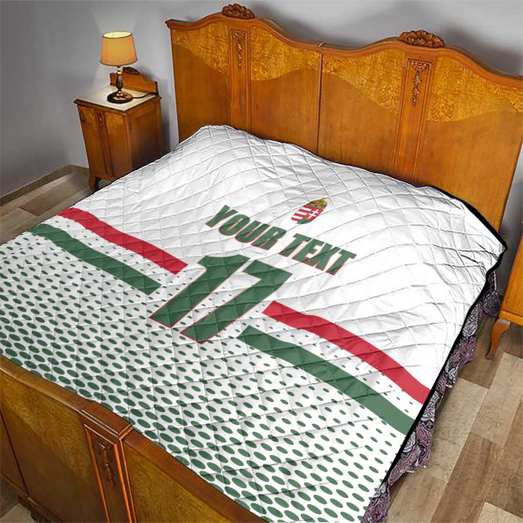 White quilt on bed with diamond quilting, Hungary flag stripes, crest and number 11