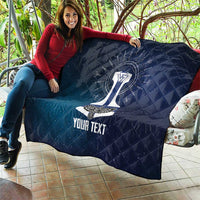 Dark blue quilted blanket with sword graphic and “YOUR TEXT” on outdoor couch
