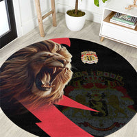 Round black carpet with angry lion print, crown crest, and red/green emblem
