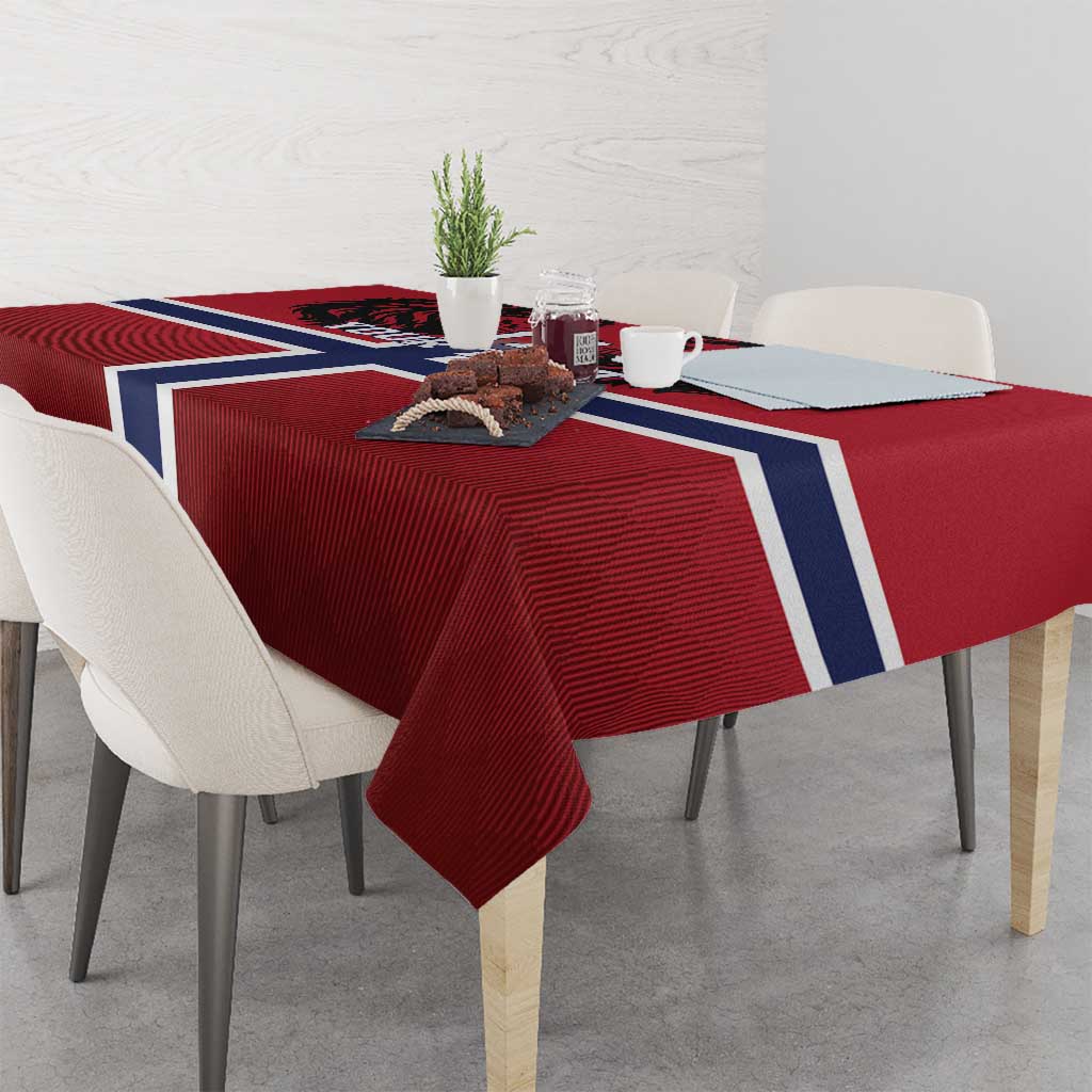 Red football tablecloth with Norway flag cross draped over table, textured fabric visible