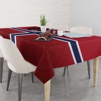 Red football tablecloth with Norway flag cross draped over table, textured fabric visible