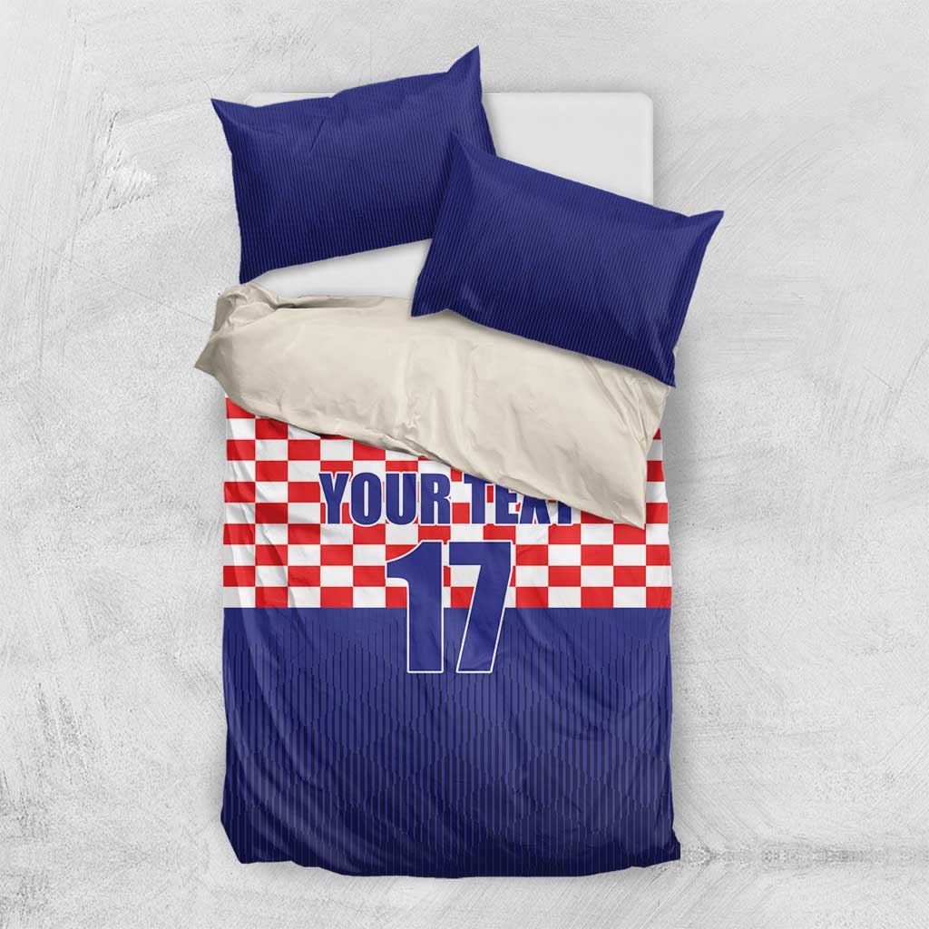 Flat-lay bedding set: blue top border, red-and-white checkered panel, Croatia crest, number 17