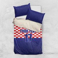 Flat-lay bedding set: blue top border, red-and-white checkered panel, Croatia crest, number 17