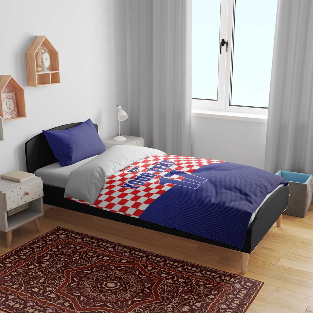 Croatia sports bedding set on bed: checkered duvet with crest and number 17, 2 blue pillowcases