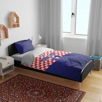 Croatia sports bedding set on bed: checkered duvet with crest and number 17, 2 blue pillowcases