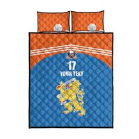 Quilt set with blue quilt featuring hockey emblem, orange pillow shams, front view.