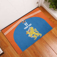 Orange and blue field hockey rubber doormat with lion crest, stripes, and 17