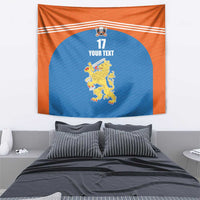 Orange wall hanging tapestry with blue center, stripes, number 17, and lion crest.