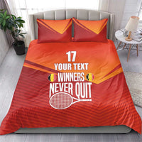 Red and orange bedding set with two matching pillows, “YOUR TEXT WINNERS NEVER QUIT” print