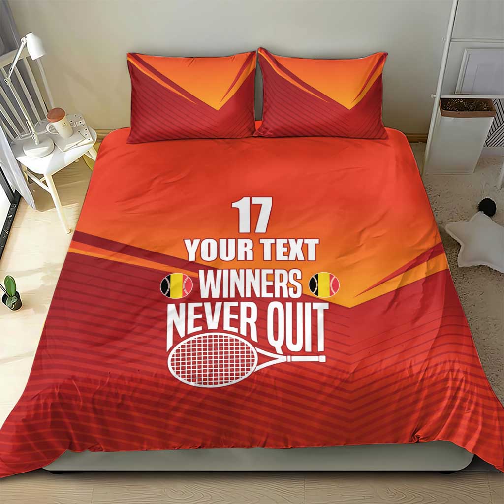 Red and orange bedding set with two pillows showing “YOUR TEXT” and tennis trophy artwork