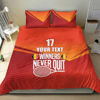 Red and orange bedding set with two pillows showing “YOUR TEXT” and tennis trophy artwork