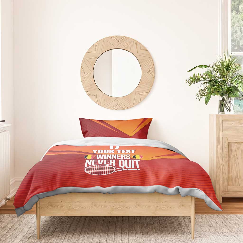 Red and orange duvet with two pillows, tennis print and “YOUR TEXT WINNERS NEVER QUIT”