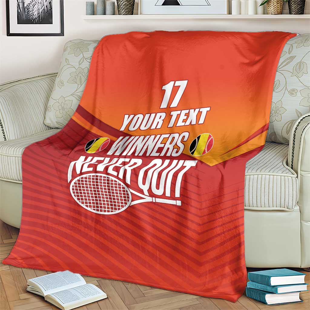 Red tennis blanket with 'WINNERS NEVER QUIT' and a tennis racket graphic