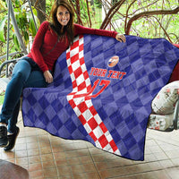 Blue quilt draped outdoors with red-and-white diamond diagonal stripe, basketball icon, “YOUR TEXT 17”