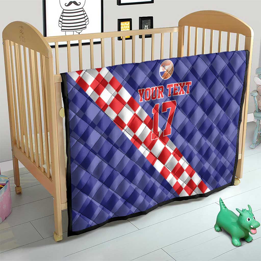 Blue quilt over crib with red-and-white check diagonal stripe, basketball icon, and “YOUR TEXT 17”